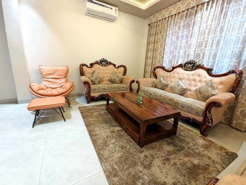 a living room with two couches and a coffee table at The Sky Imperial Sethji Ni Wadi in Indore