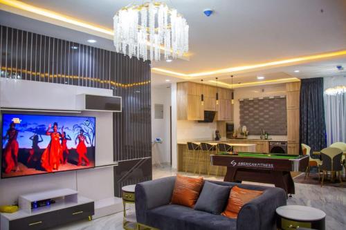 a living room with a tv and a pool table at Frotech property in Lekki