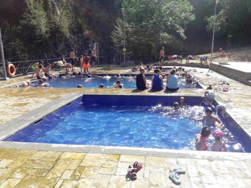 a group of people sitting in a swimming pool at Guesthouse in Sadgeri in Borjomi