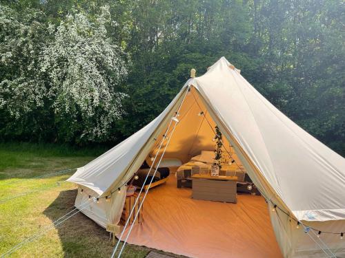 a white tent with a bed in it at Elm Bell Tent in Droitwich