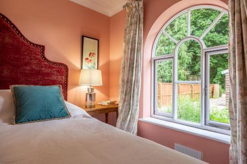 a bedroom with a bed and a window at The Gate House BB in Wymondham