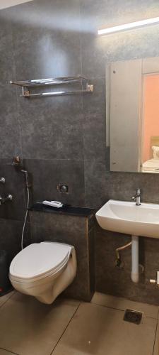 a bathroom with a toilet and a sink at GREEN TERRUS BUSINESS CLASS HOTEL in Chennai