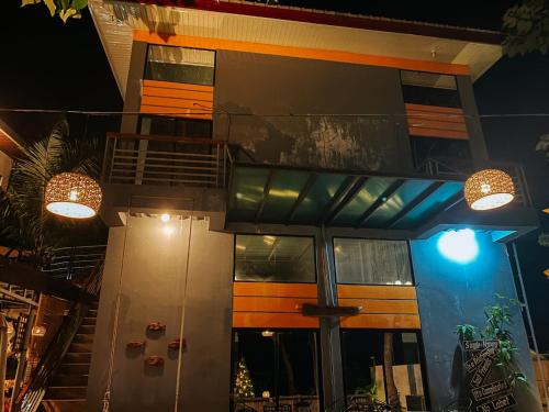 a house with two lights on the side of it at The River House - Loft Units in Vigan