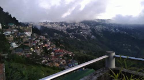 a view of a city on a mountain at Riva Homestay and Restaurant , Darjeeling in Darjeeling