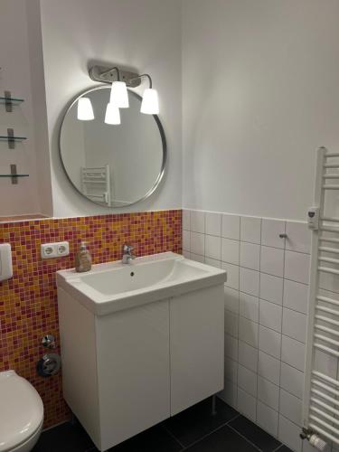 a bathroom with a white sink and a mirror at Villa Josephine App. 14 in Kühlungsborn