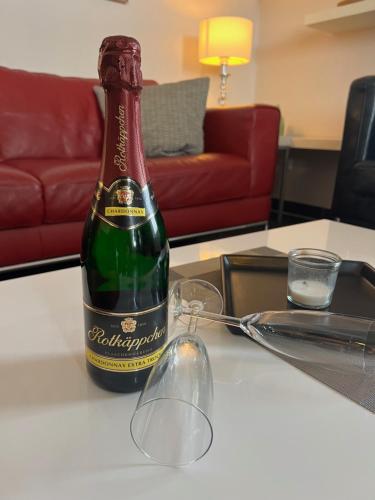 a bottle of champagne sitting on a table at Villa Josephine App. 14 in Kühlungsborn