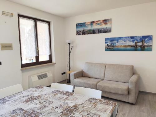 a living room with a couch and a table at Le Giare Apartments Garda in Garda