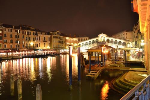 a city at night with a river and buildings at Hotel Terme Abano Verdi in Abano Terme