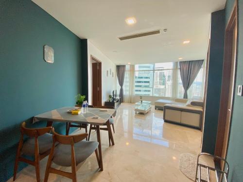 a living room with a table and chairs and a couch at Vortex Premium Suites KLCC by SCHIEN in Kuala Lumpur