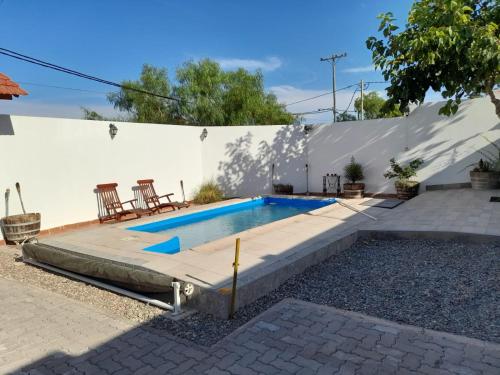 a swimming pool in the backyard of a house at Challao Dream in El Challao