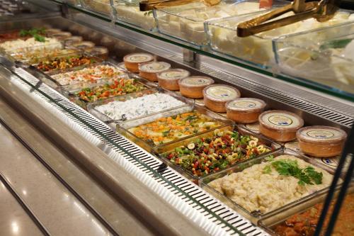 a buffet filled with lots of different types of food at Mihman Hotel in Tuzla