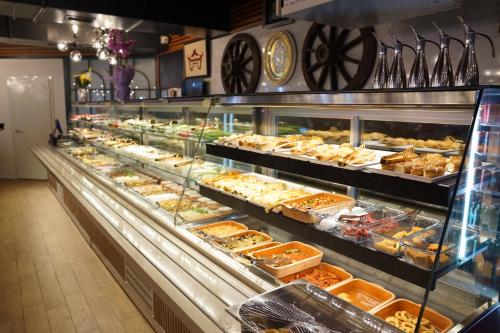 a bakery filled with lots of different types of pastries at Mihman Hotel in Tuzla