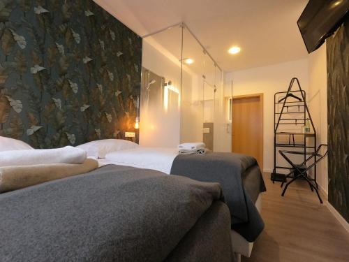 a bedroom with two beds and a wall mural at Landgasthof & Hotel Waldeck in Treuen