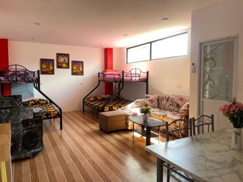 a living room with two bunk beds and a table at Zenhouse Calayo in Nasugbu