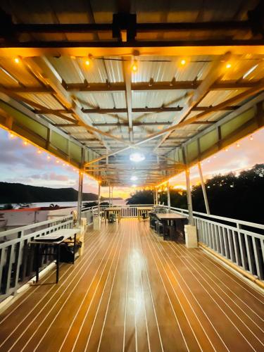 a deck of a boat with a sunset in the background at Zenhouse Calayo in Nasugbu