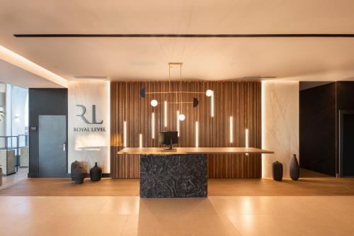 a lobby with a bar with a chandelier at Barceló Playa Blanca Royal Level - Adults Only in Playa Blanca