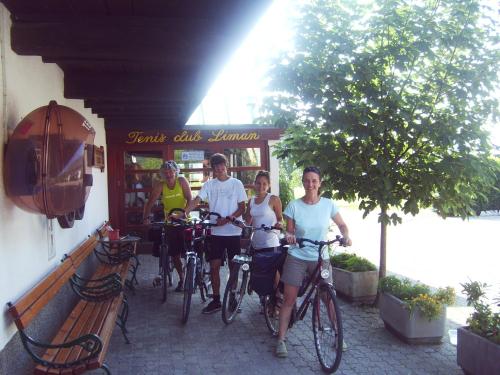 a group of people riding bikes outside of a restaurant at Guest House Turistična kmetija Plaznik in Ljubno