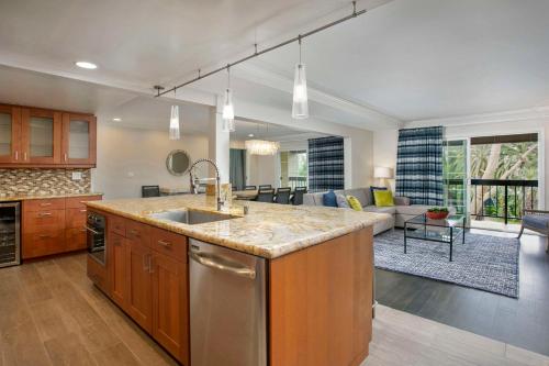 a kitchen with a sink and a living room at Hyatt Regency Newport Beach in Newport Beach