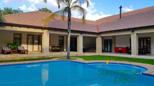 a house with a swimming pool in front of it at Summerset Place Country House in Bela-Bela