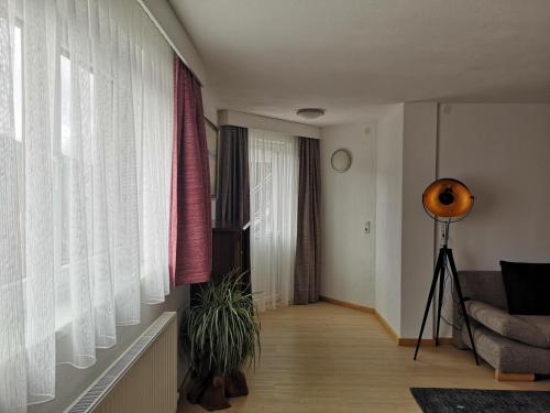 a living room with a couch and a window at Ferienwohnung Tanzer in Ellbögen