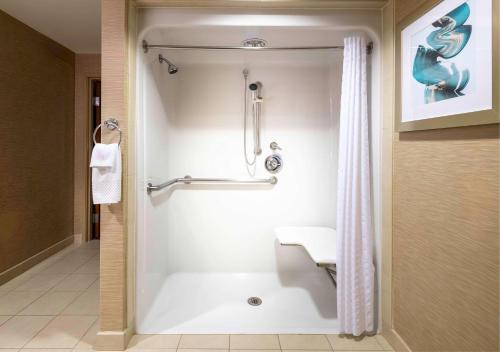 a bathroom with a shower with a shower curtain at Hilton St. Petersburg Carillon Park in St. Petersburg