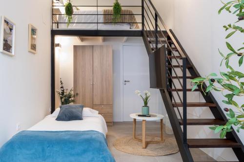 a bedroom with a bed and a spiral staircase at Lore Loft Valencia in Valencia