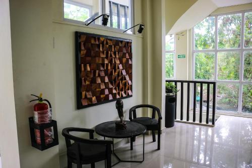 a dining room with a table and chairs and windows at ONYX B&B Bed and Breakfast in Euscara