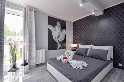 a bedroom with a bed with two stuffed animals on it at Apartment in Międzyzdroje with Furnished, Green Balcony SeaView by Rent like home in Międzyzdroje