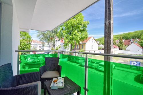 a room with a green balcony with chairs and a table at Apartment in Międzyzdroje with Furnished, Green Balcony SeaView by Rent like home in Międzyzdroje