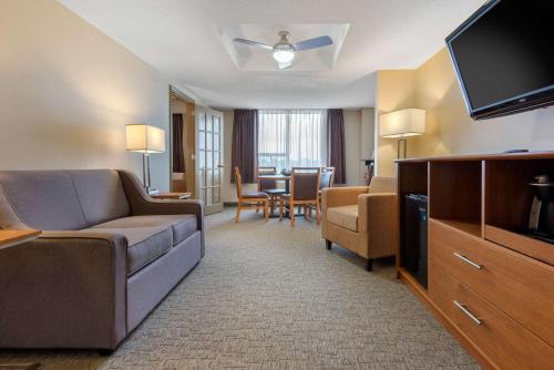 a living room with a couch and a flat screen tv at Quality Inn & Conference Centre Downtown Sudbury in Sudbury