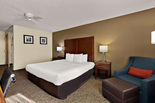 a hotel room with a bed and a blue chair at Comfort Inn & Suites Sequoia Kings Canyon in Three Rivers
