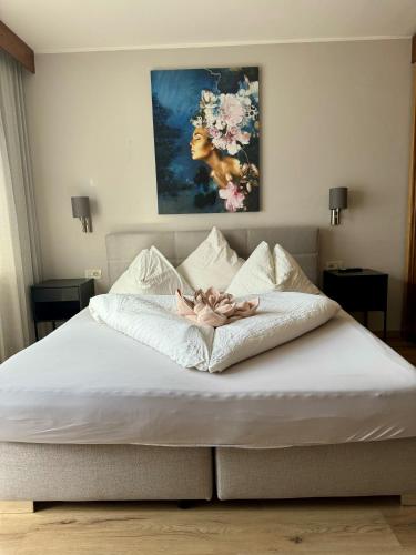 a woman laying on top of a bed at Hotel Residence MaVie in Lagundo