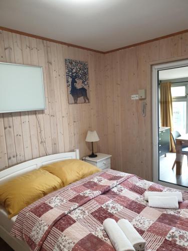 a bedroom with a bed with a quilt on it at Apartamenty pod Wilczakiem in Złotoryja