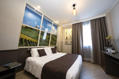 a hotel room with a bed and a large window at Hotel Plaza in Turin