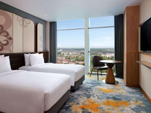 Una cama o camas en una habitación de Mercure Pangkalan Bun