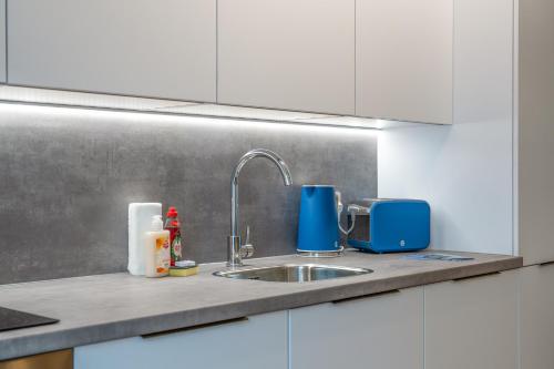 un bancone della cucina con lavandino e apparecchio blu di Modern Stylish 2 bedroom apartment in the heart of Potters Bar a Potters Bar