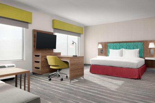 a hotel room with a bed and a desk at Hampton Inn & Suites Durham University Medical Center in Durham