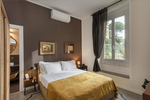 a bedroom with a large bed and a window at Classy Apartment in Portofino by Wonderful Italy in Portofino