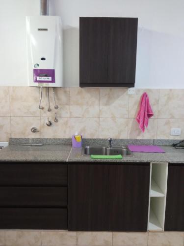 a kitchen with a sink and a counter top at Violeta Monoambiente in Salta