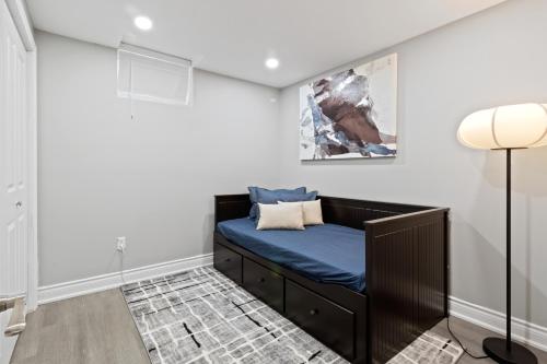 a room with a bench with a blue cushion at Luxurious and spacious 3 bedroom apartment in Mississauga