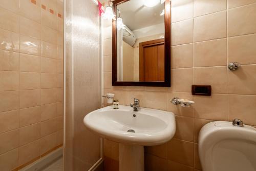 ラ・トゥイールにあるAPT. Planibelのバスルーム(洗面台、トイレ、鏡付)