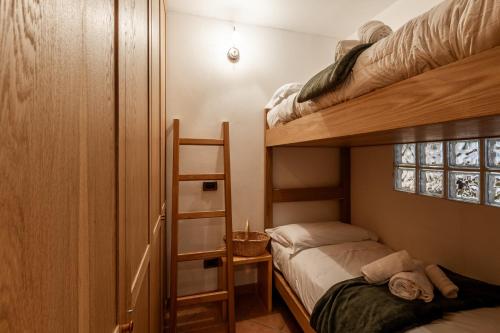 ラ・トゥイールにあるAPT. Planibelのベッドルーム1室(二段ベッド2台、はしご付)
