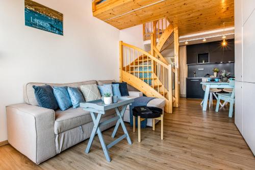 a living room with a couch and a table at KORZO Lipno in Lipno nad Vltavou
