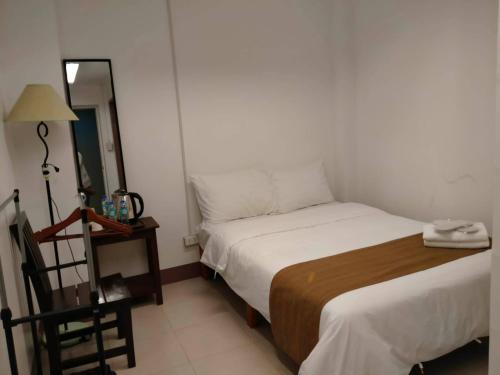 a small bedroom with a bed and a mirror at Skyland Garden Hotel and Resort in Baguio