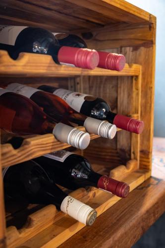 a bunch of wine bottles in a wooden wine rack at Africa House in Hoedspruit