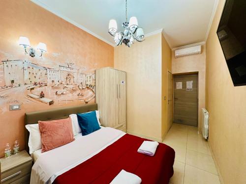 罗马Rome Innitaly Affittacamere o GuestHouse的卧室里有一张床，墙上挂着一幅画