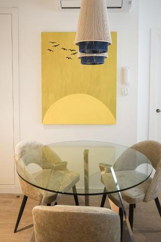 a dining room with a glass table and two chairs at Lumen Mare by SH Hoteles in Valencia