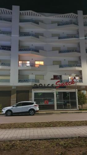 a car parked in front of a large building at Coup de cœur a 5mn de l aéroport in Nouaceur