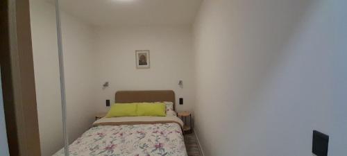 Dormitorio pequeño con cama con almohada amarilla en Apartment Vanja 1 - near city center en Krapina