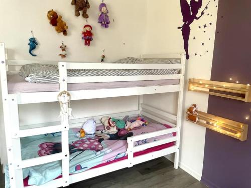 a bedroom with two bunk beds with toys on them at Maison-Triplex rare avec jardin JO2024 in Villeneuve-la-Garenne